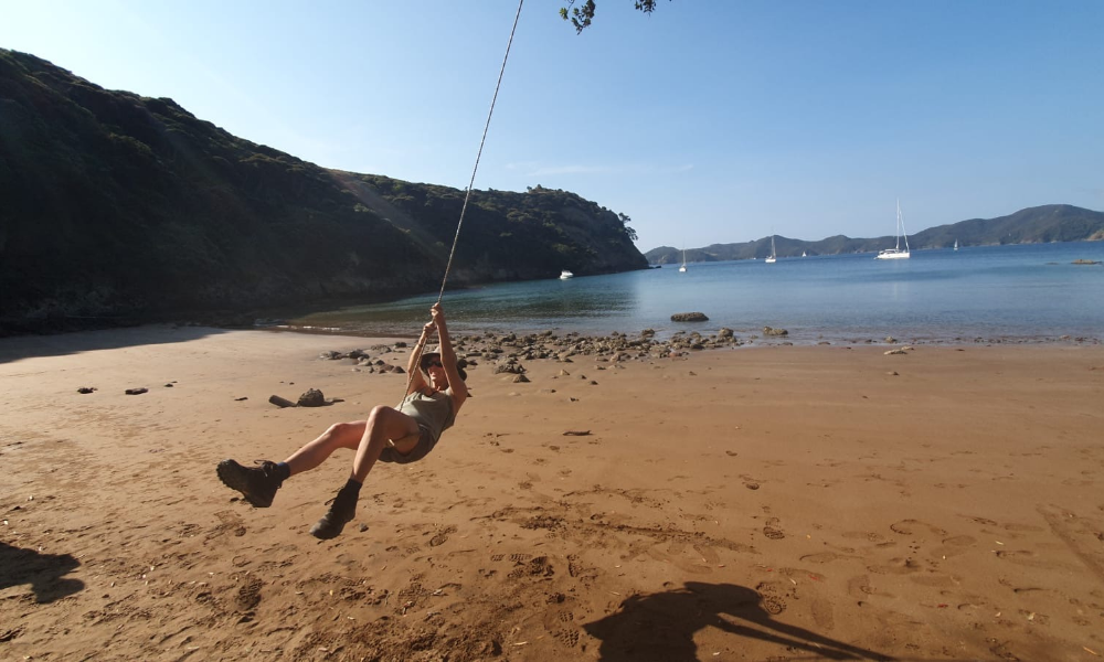 Girl on rope swing Hauraki Gulf