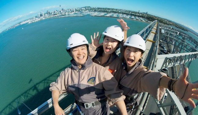 Group taking a photo on top of Auckland Harbour Bridge