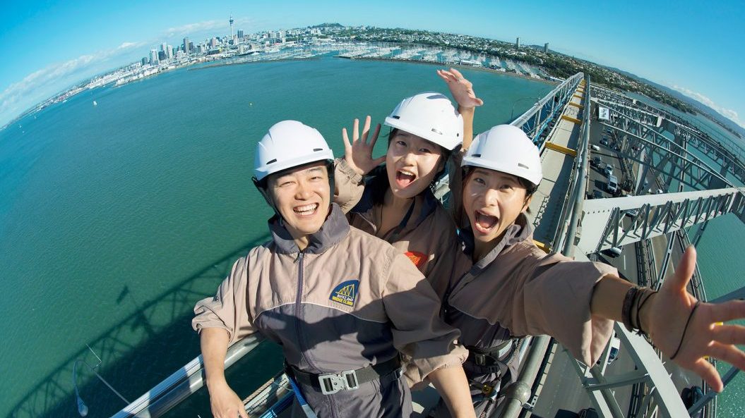 Group taking a photo on top of Auckland Harbour Bridge