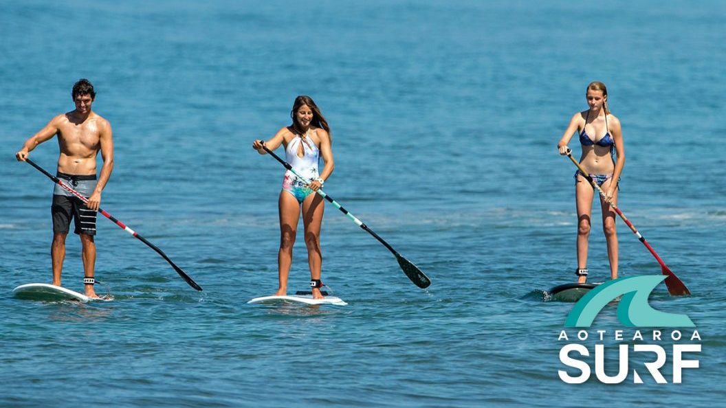 Friends paddle boarding Auckland